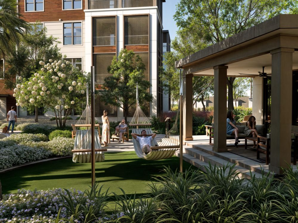 Man drinking a cup of coffee in front of a plant wall