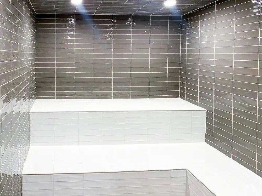 The Lucent steam room amenity with gray tile backsplash