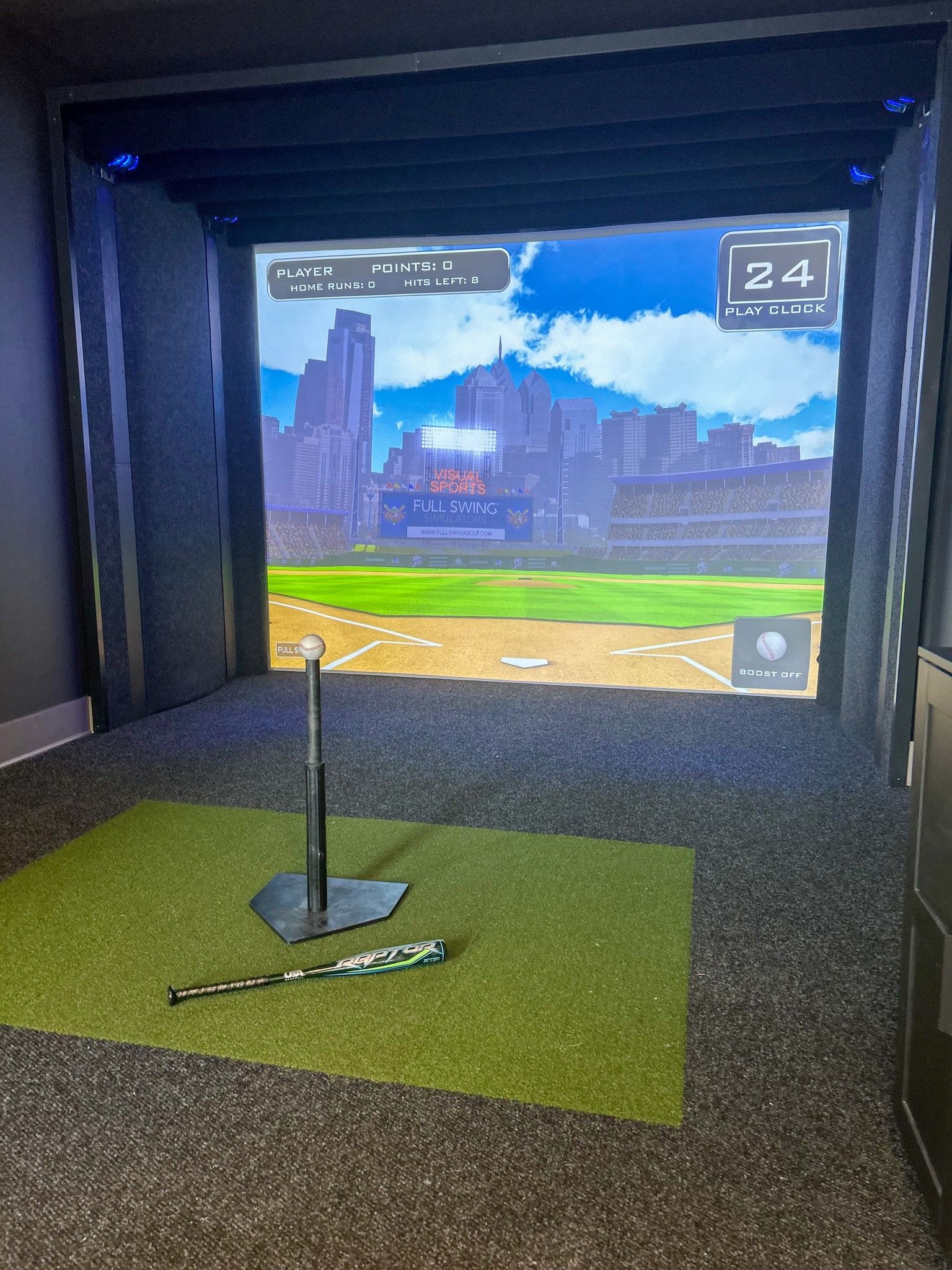 Baseball equipment laying in front of sports simulator at The Lucent apartments