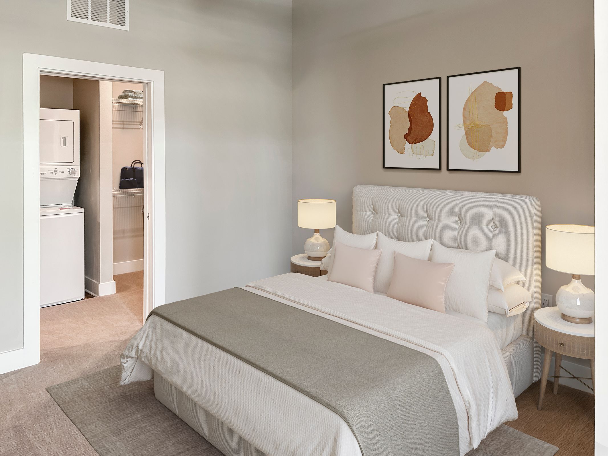 Bed and hanging pictures inside luxury one bedroom Kissimmee apartment