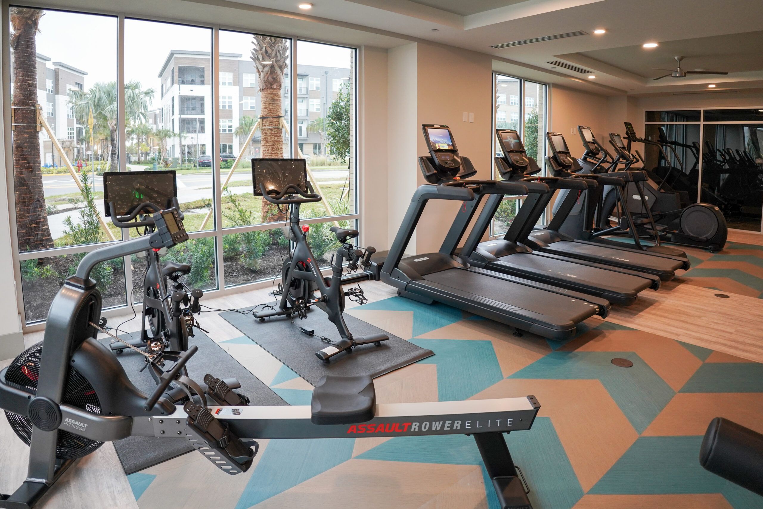 Furnished jewel box with furniture, designer lighting, and floor-to-ceiling windows facing the pool