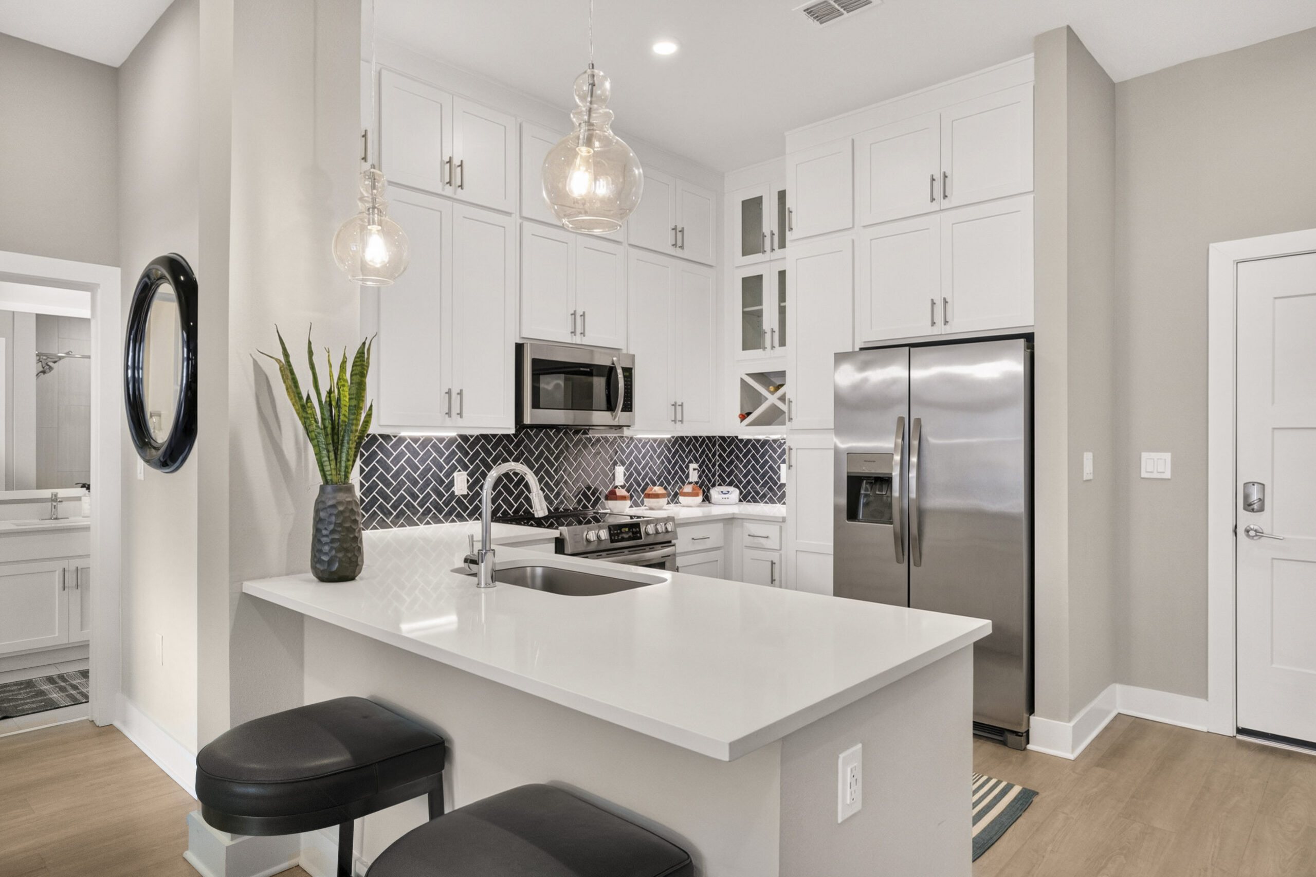 Bed and hanging pictures inside luxury one bedroom Kissimmee apartment