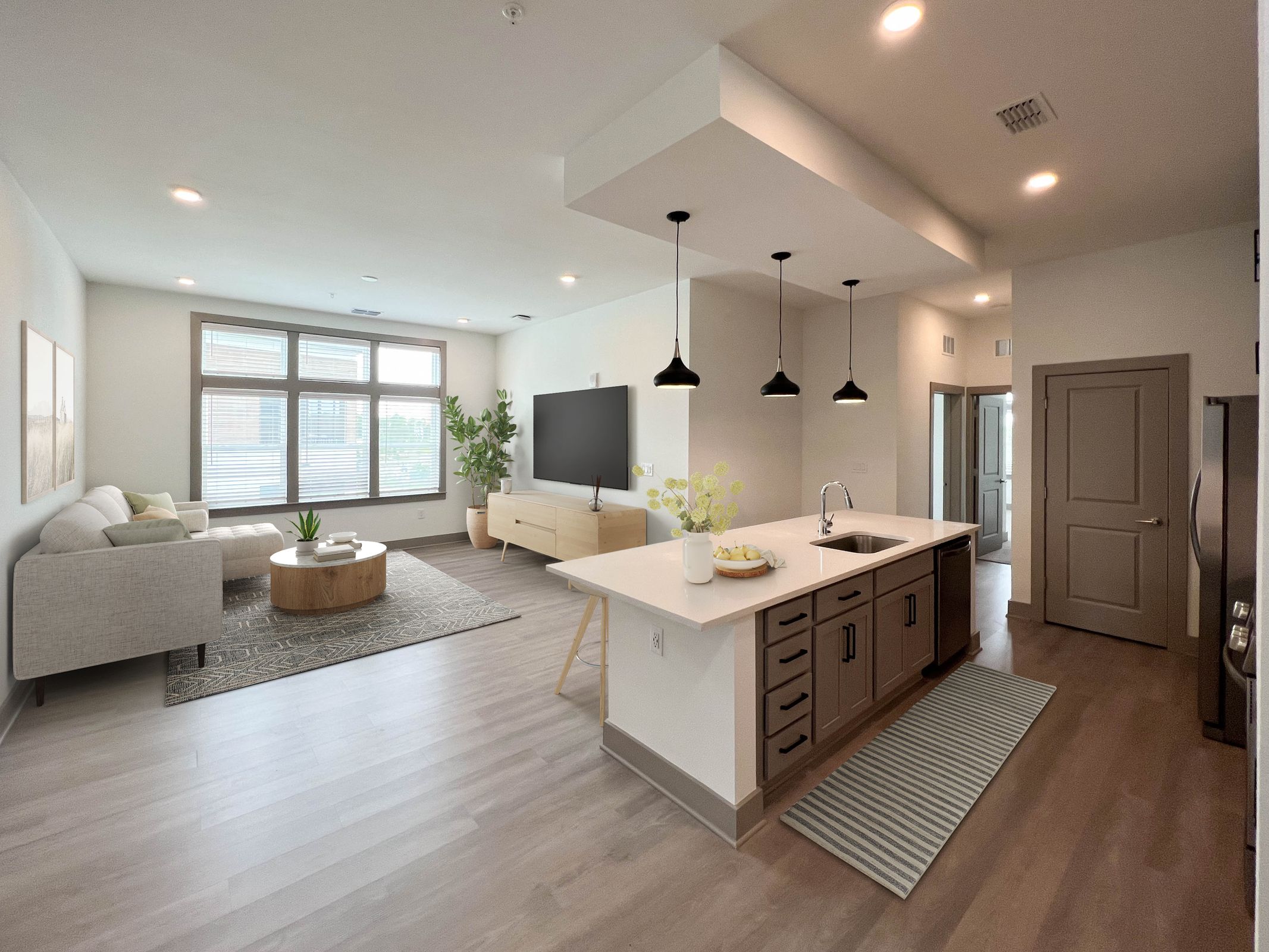 Bed and hanging pictures inside luxury one bedroom Kissimmee apartment