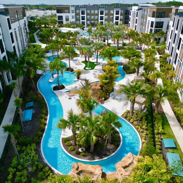 Lazy river surrounded by palm trees at The Lucent at Sunrise Apartments