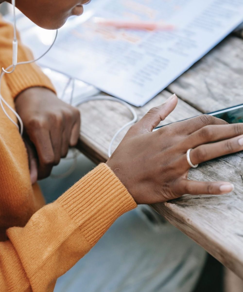 woman using phone on table
