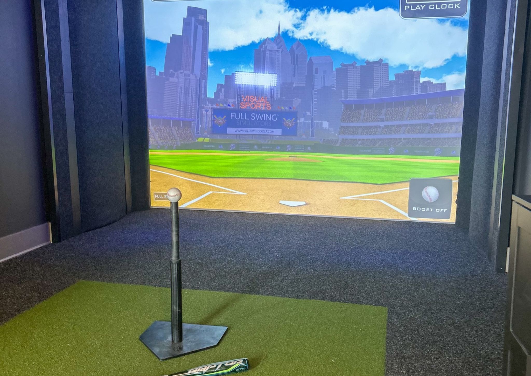 Baseball equipment laying in front of sports simulator at The Lucent apartments